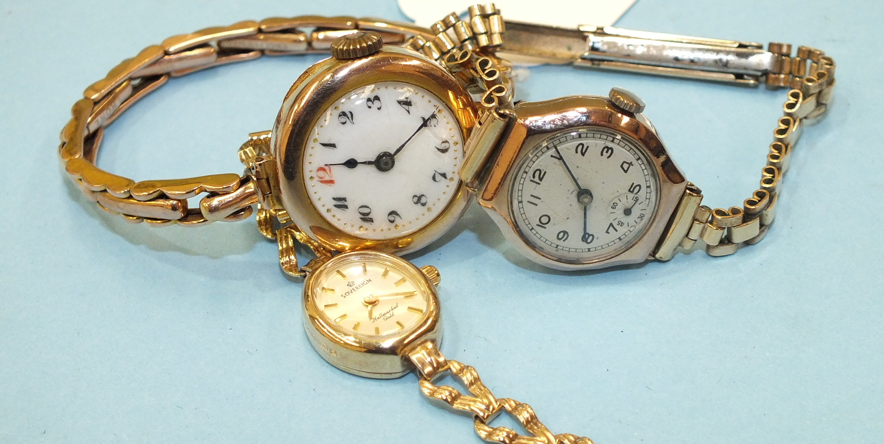A ladies 9ct-gold-cased wrist watch (af), on gold expanding bracelet, another on plated bracelet and
