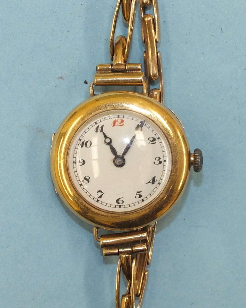 A ladies 18ct-gold-cased wrist watch with white enamel dial and "Peerless" movement, on 9ct gold