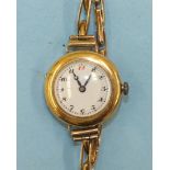 A ladies 18ct-gold-cased wrist watch with white enamel dial and "Peerless" movement, on 9ct gold