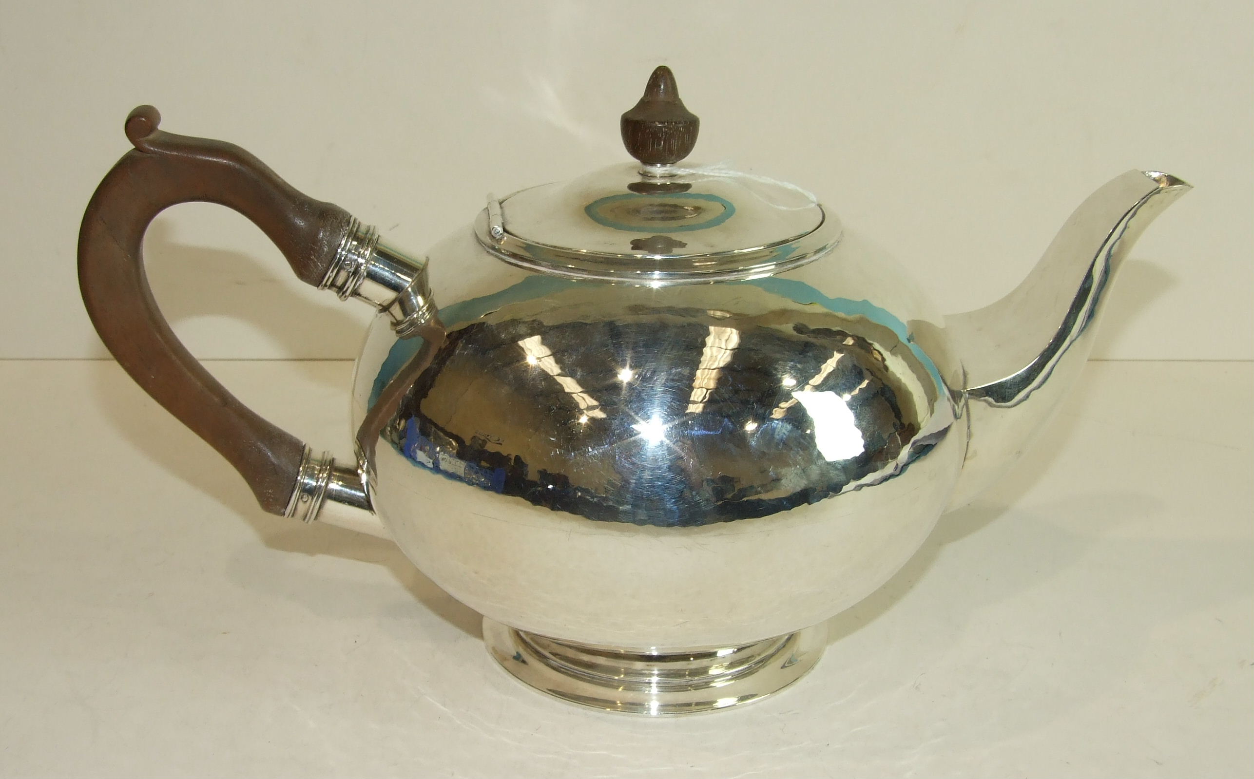 A large silver bullet-shaped teapot with wood handle and finial, 17cm high, Birmingham 1939,