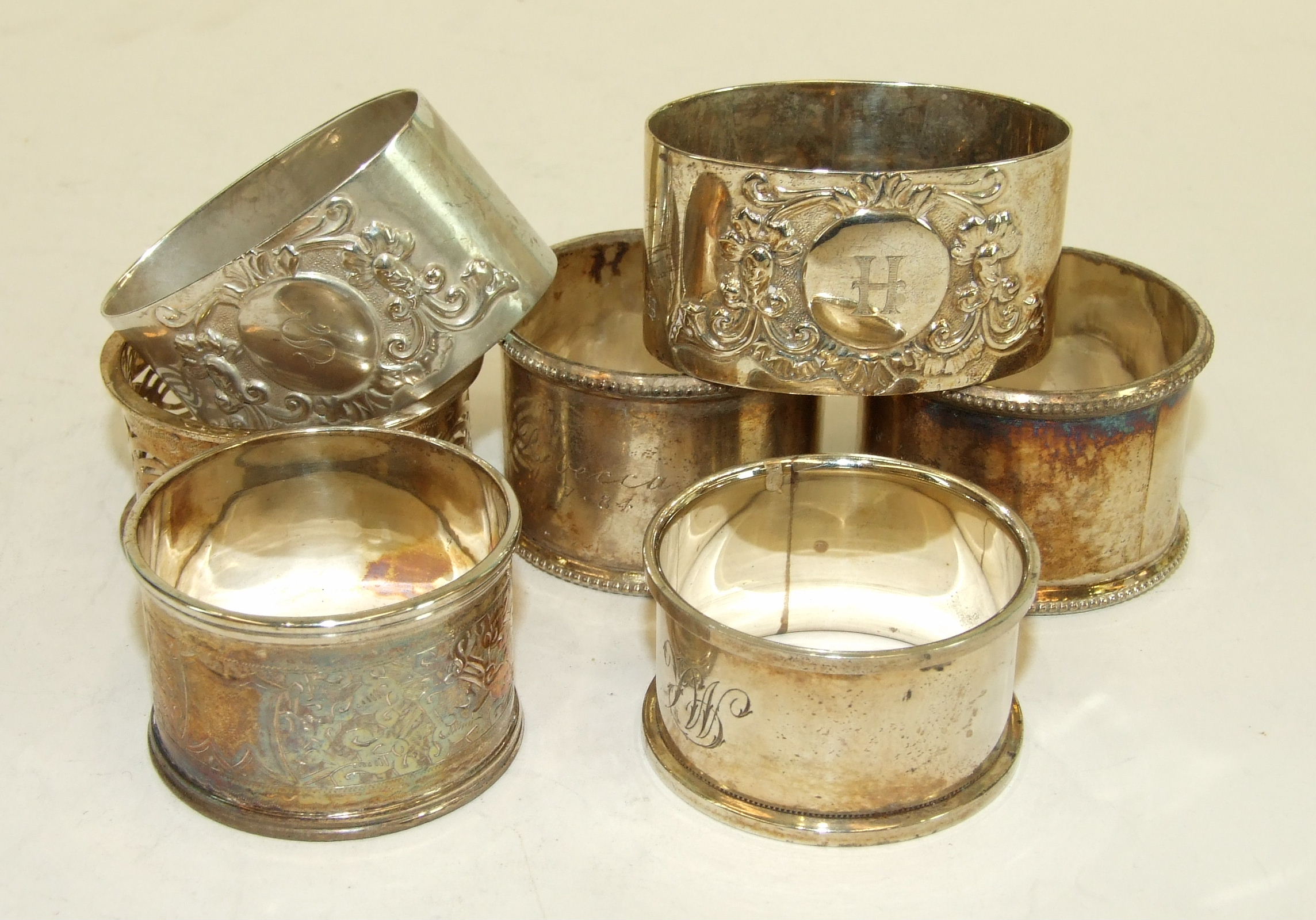 A collection of seven various silver napkin rings, total weight ___5oz, (7).