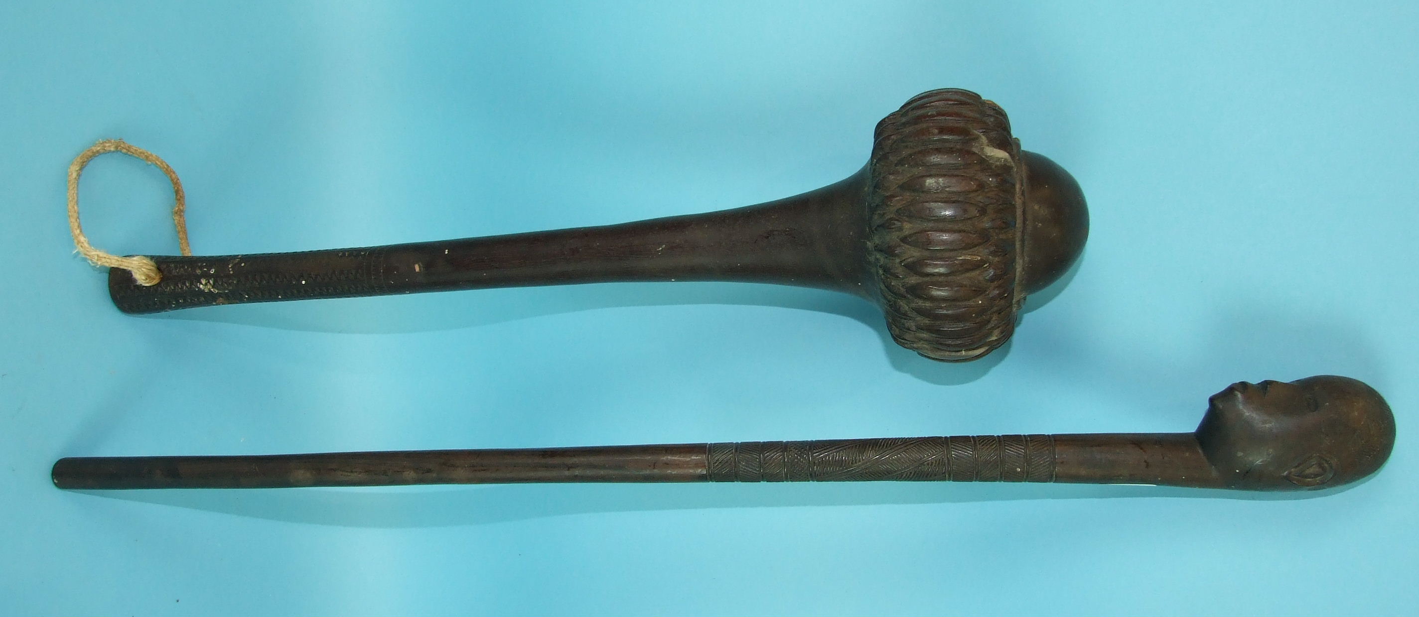 An antique Fijian ula throwing club, the bulbous head with carved design, the tapering handle with