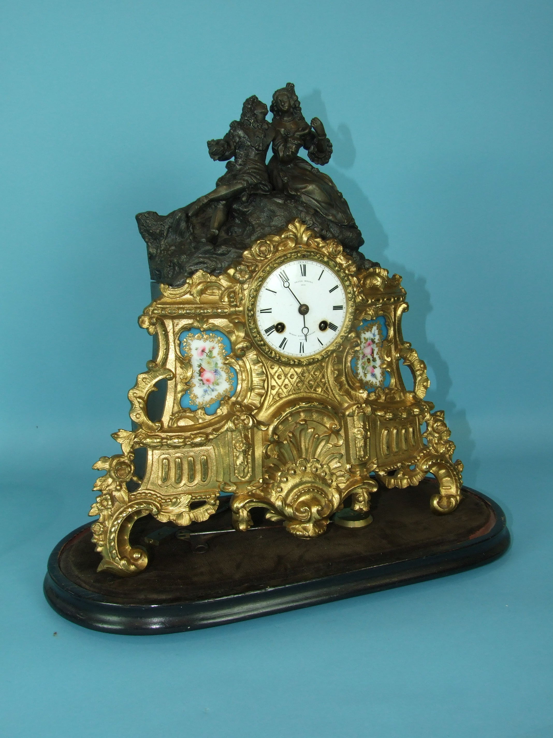 A 19th century French spelter mantel clock, the part-bronzed part-gilt figural case with two - Image 2 of 2