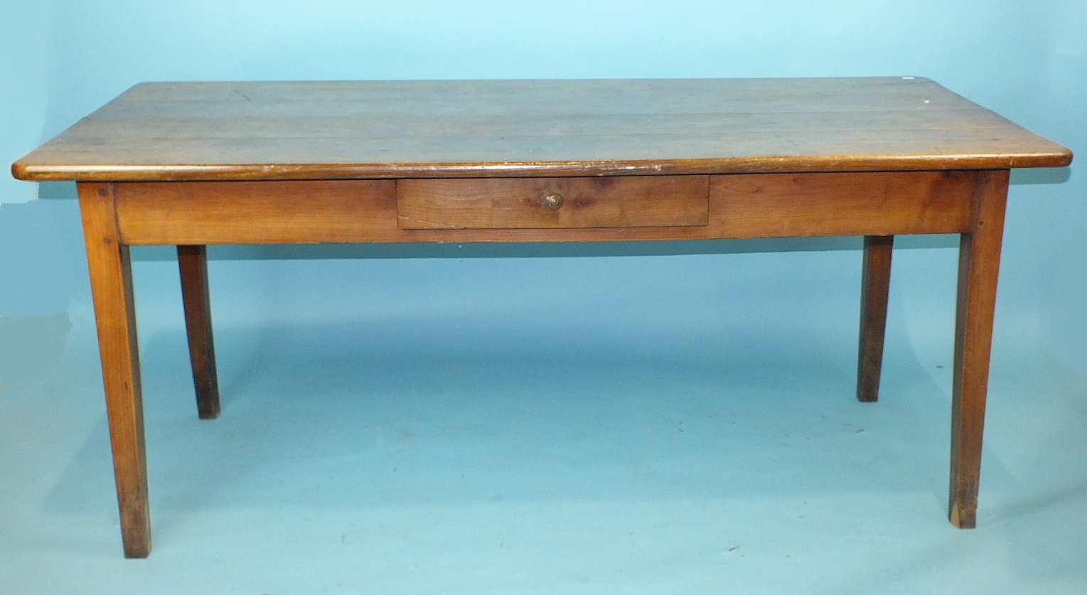 A fruit wood and elm plank-top table with end draw, on square tapered legs, 180cm x 81cm wide.