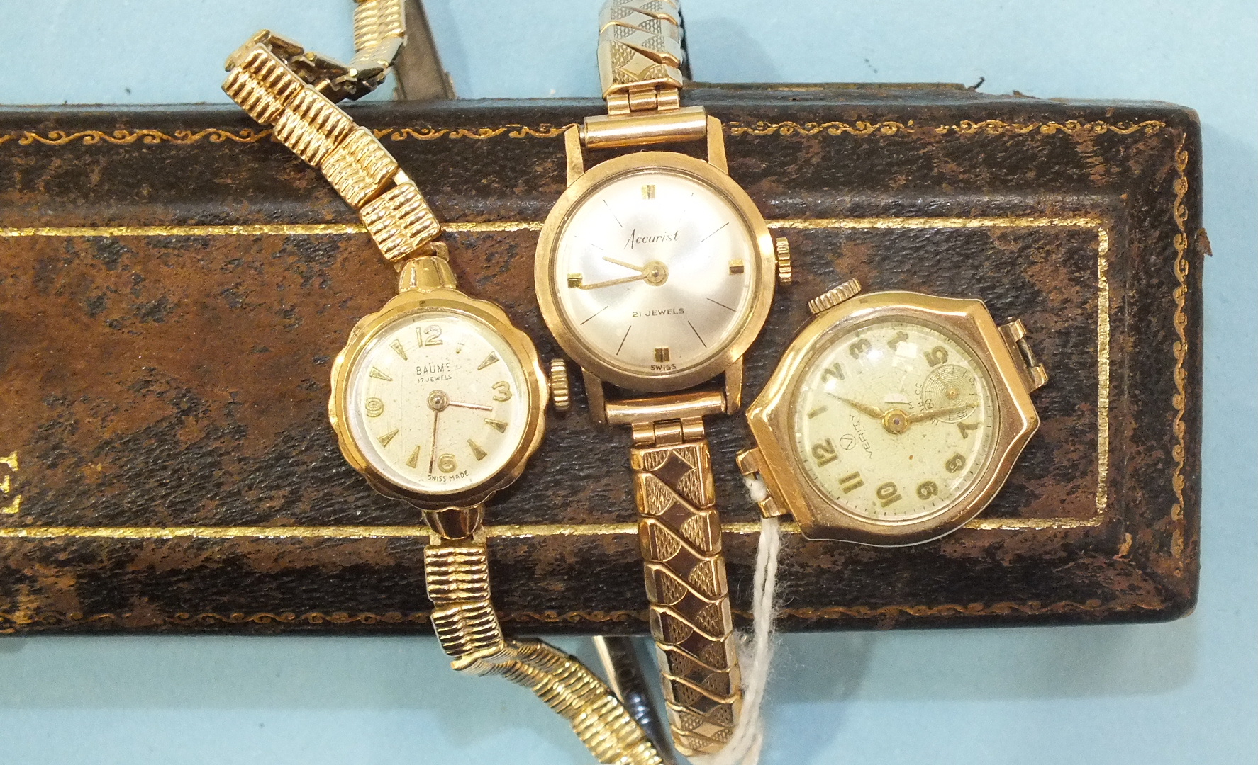 Baume, a ladies 9ct-gold-cased wrist watch on plated bracelet, boxed, and two other ladies wrist