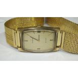 Omega de Ville, a gents wrist watch of rectangular cushion shape, the gilt face with baton numerals,