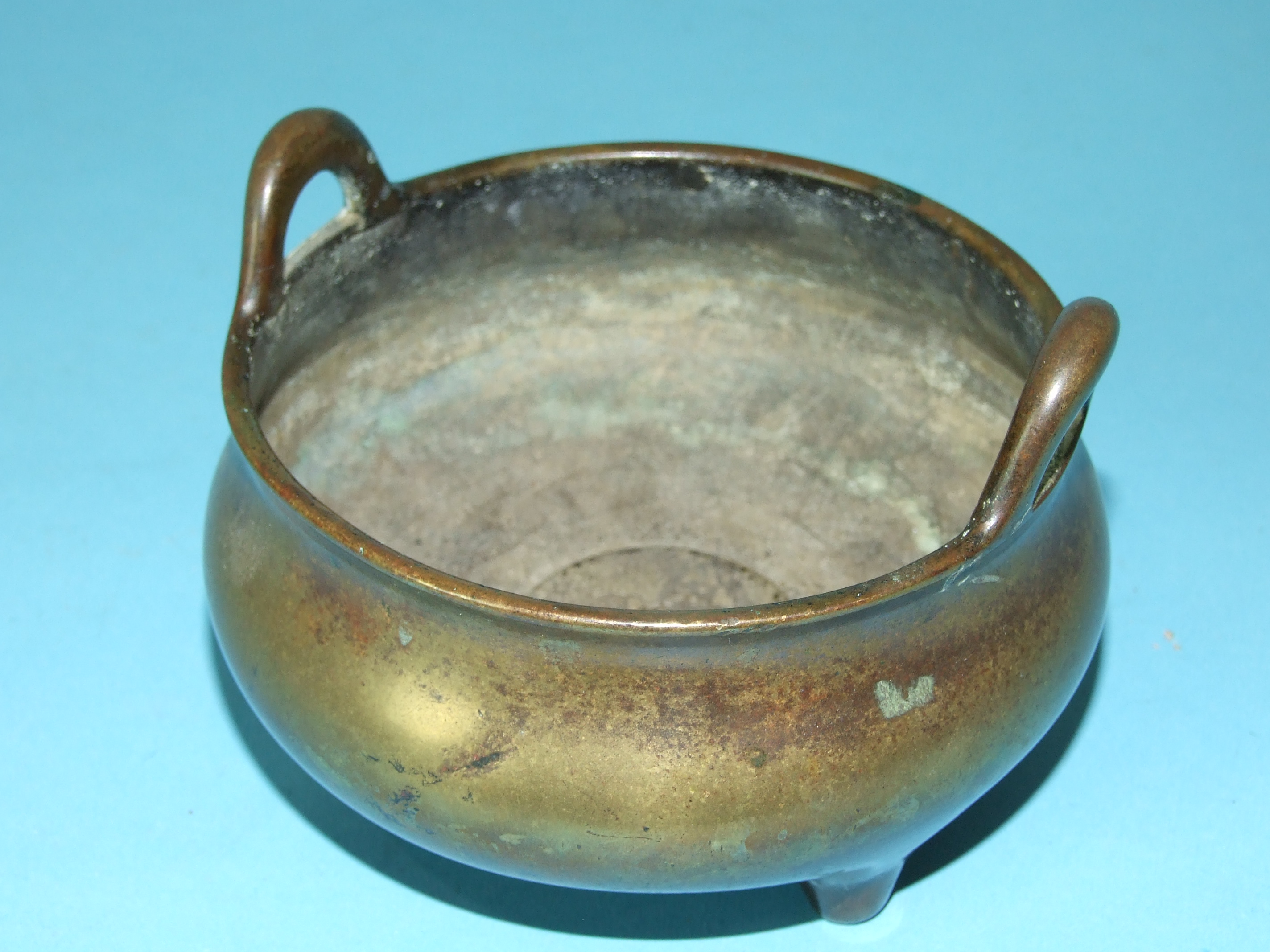 A Chinese antique bronze censer with two small handles, on short legs, impressed six character