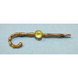 A 15ct gold bar brooch in the form of a bamboo walking cane, collet set a round cut peridot, 4.