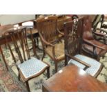 A mahogany shaped spindle-back armchair on cabriole front legs joined by cross-stretchers,