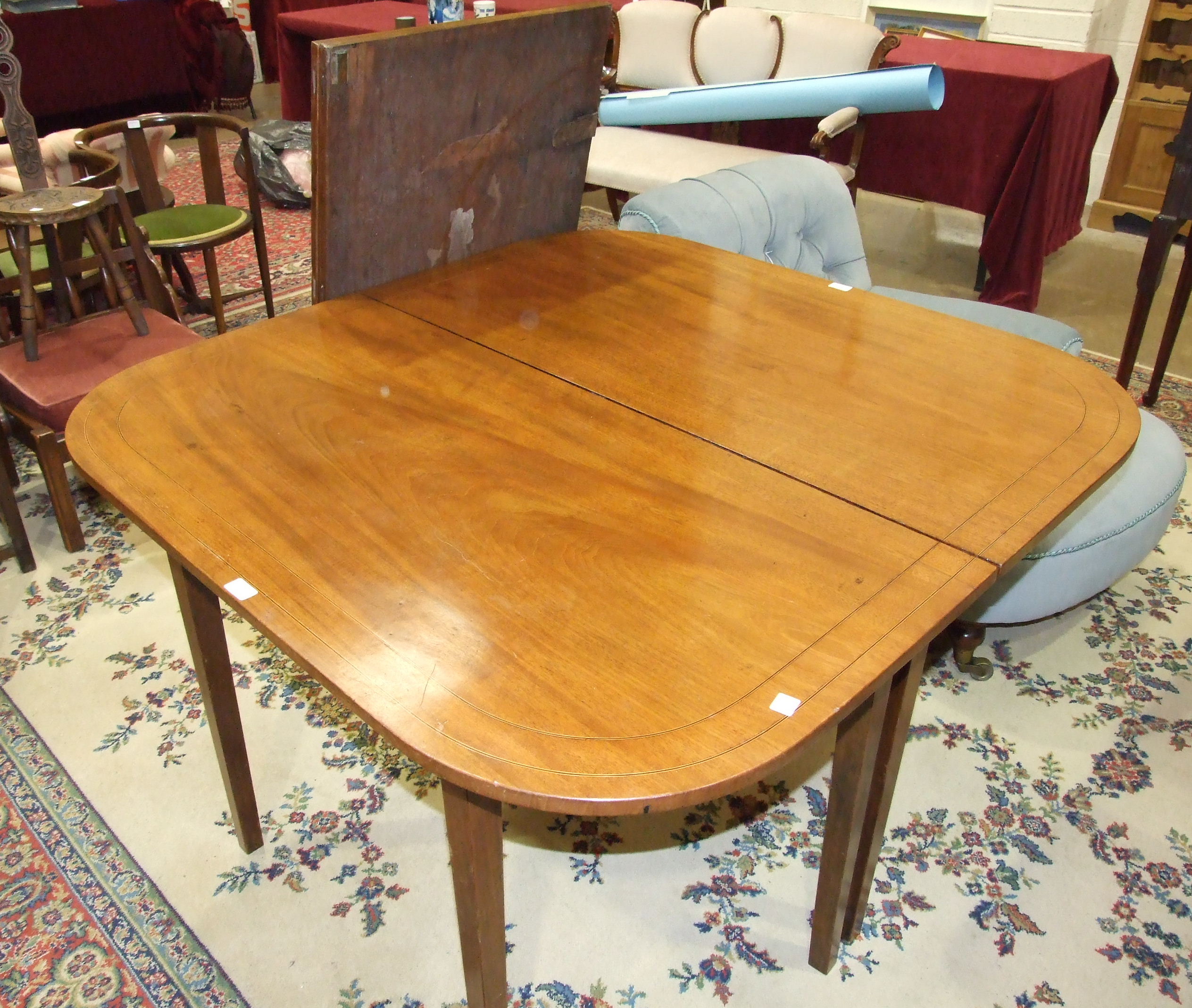 A Georgian mahogany D-end dining table on square tapering legs and having two leaves, 249 x 120cm