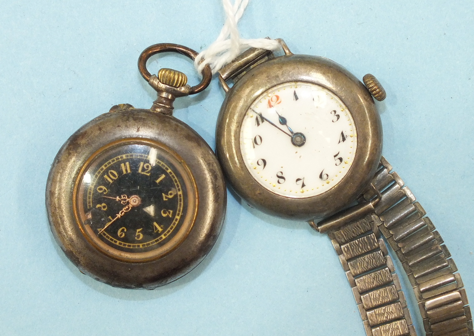 A ladies Continental silver-cased wrist watch on silver bracelet and a gun metal cased keyless fob