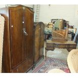 A walnut bedroom suite comprising a two-door wardrobe fitted with two drawers, 95cm wide, a