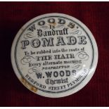 A "Woods Is Dandruff Pomade" pot and lid "To be rubbed into the roots of the hair every alternate