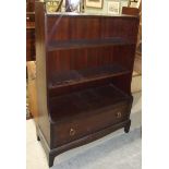 A Stag bookcase and two dressing table mirrors, (3).