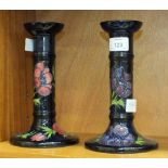 A pair of late-20th century Moorcroft Pottery candlesticks decorated with anemones on a dark blue