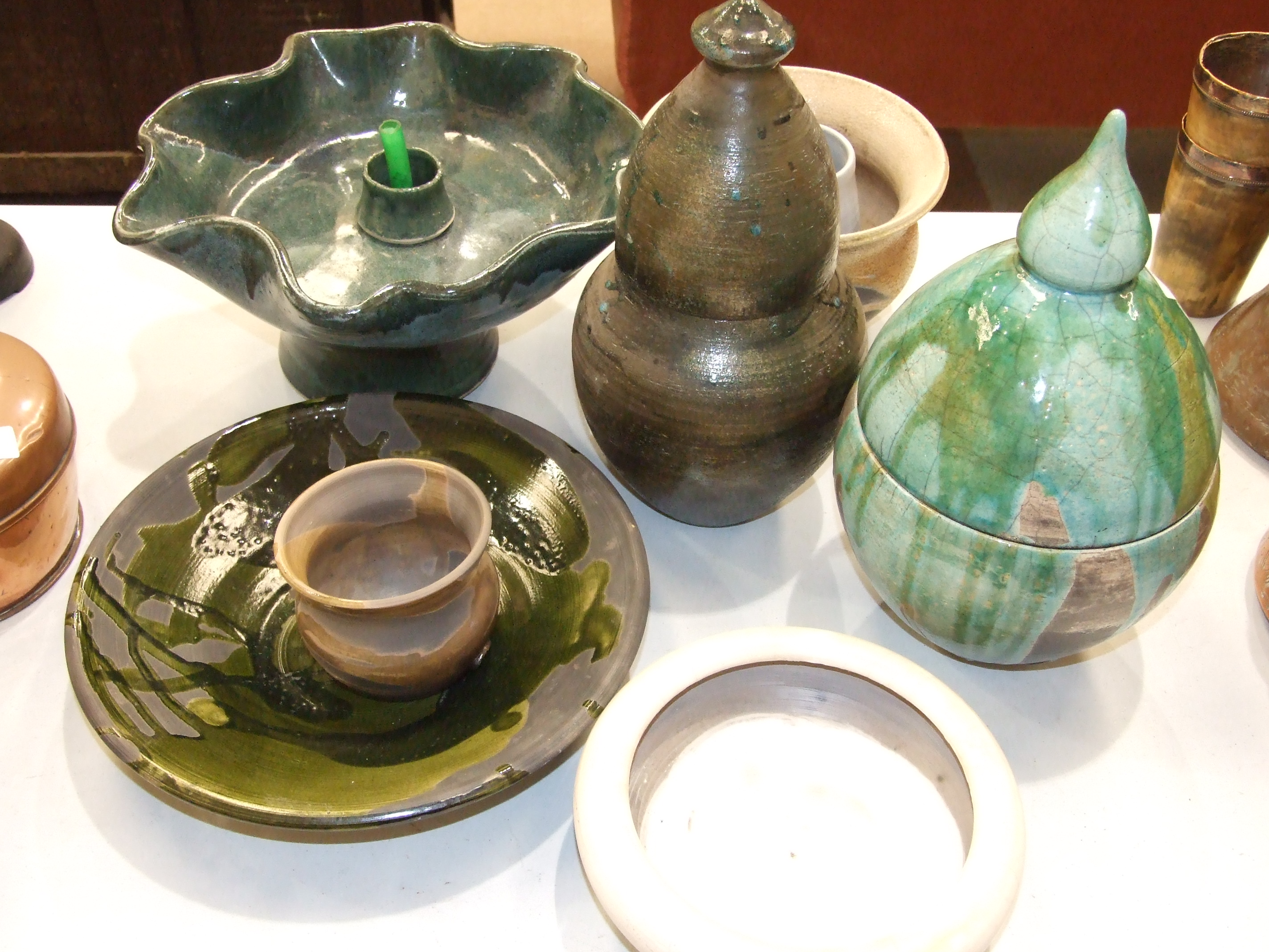 A collection of glazed pottery objects, all marked ME, including a table water feature and two domed