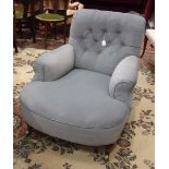A late-19th century upholstered button-back deep-seated low armchair on turned front legs with brass