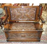 A mid-20th century oak monk's bench with carved decoration to top, seat and front, 106.5cm wide.