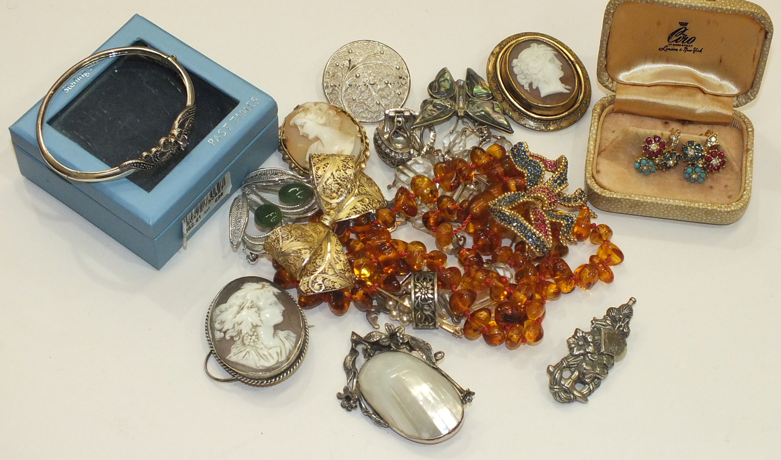 Three shell cameo brooches, a small quantity of silver jewellery and other jewellery.
