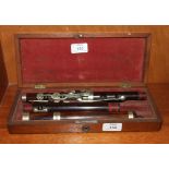 A vintage rosewood flute, 67cm overall, af, in fitted box.