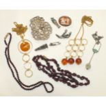 Two gold plated pendants on chains with amber drops, two garnet bead necklaces and other items.