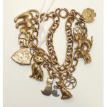 A 9ct gold curb-link watch chain converted to a bracelet with one locket and eleven charms, mainly