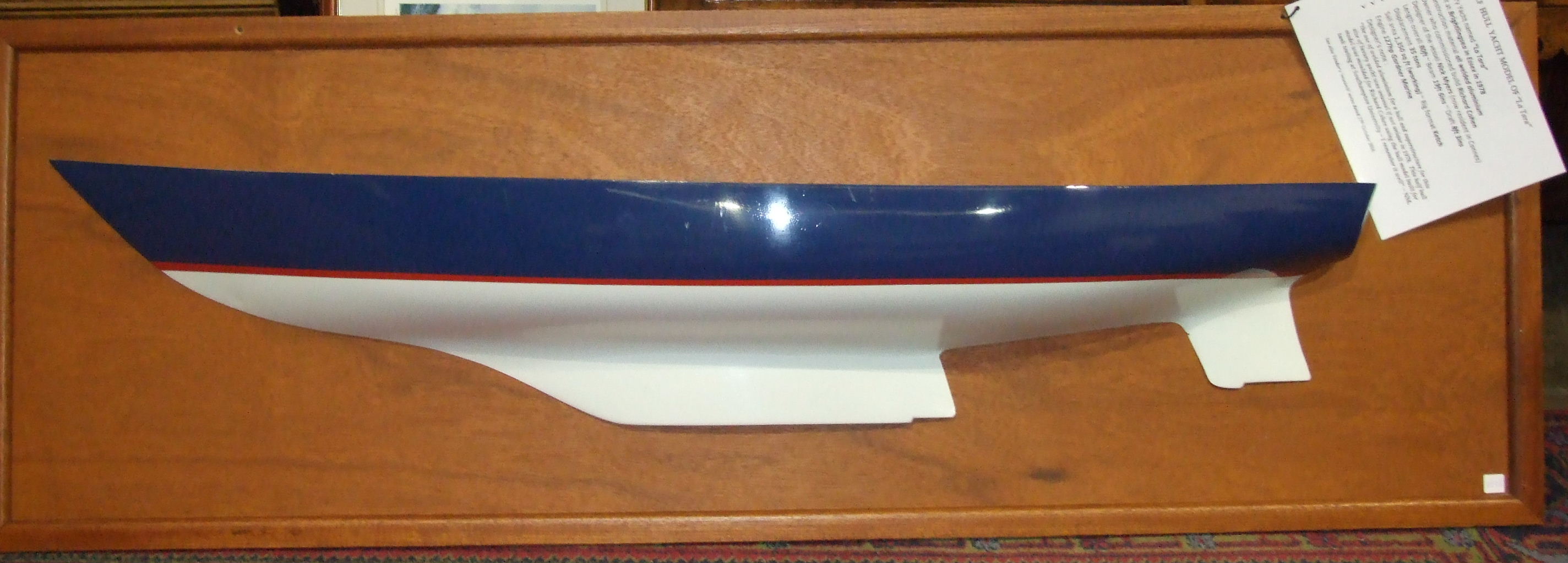 A modern fibre glass half-hull model of the sailing yacht "La Tara", hull length 154cm, mounted on