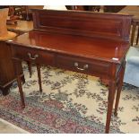 An Edwardian mahogany hall table, the low back above a rectangular top and two frieze drawers, on