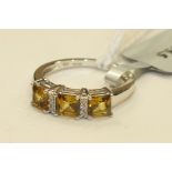 A yellow tourmaline and white zircon ring with 9k white gold mount, size J, 2.1g with certificate of