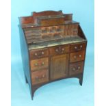 A late-19th/early-20th century mahogany lady's bureau, the fall front and fitted interior above an