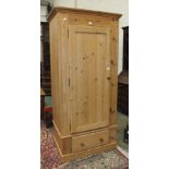 A modern pine single-door wardrobe on drawer base, 95cm wide.