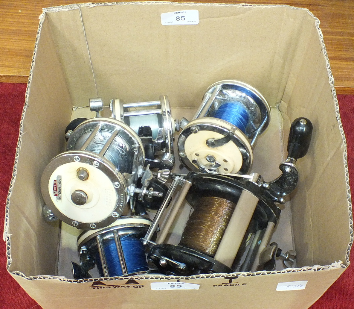 A collection of five multiplier fishing reels, including Garcia Mitchell 624 x2, 622, 602A and a G &