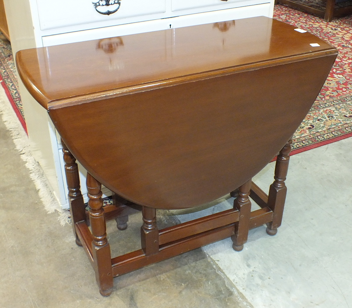 A mid-20th century mahogany low bookcase, the rectangular top above a pair of glazed doors, on base,