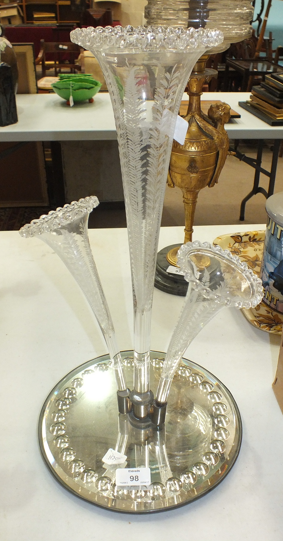 A 19th century English three-branch epergne with fern-engraved flutes, on a circular mirrored stand,