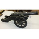 An iron model of a cannon, 73cm long, 30cm high.