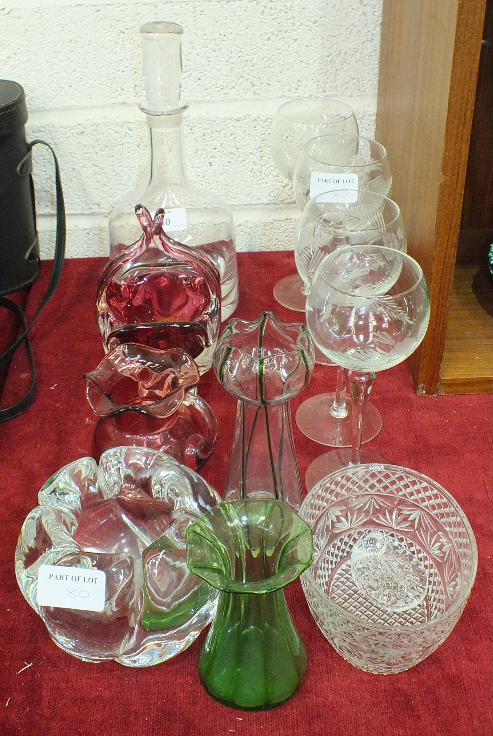 A cranberry glass jug with clear handle, 9cm high, wine and drinking glasses and other glassware.