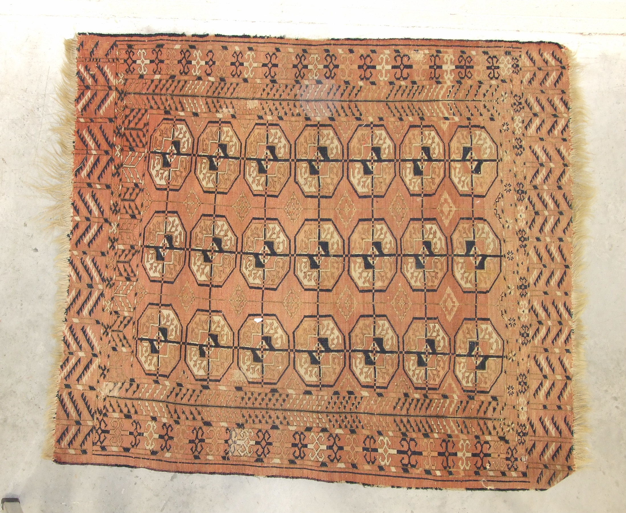 A mid-20th century wool rug, red field with central hexagonal medallions, figures leading camels and - Image 2 of 3