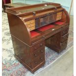 A Victorian mahogany cylinder writing desk, the pull-out desk top and fitted interior above two