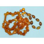 A string of honey-coloured amber flattened beads, 45g, a silver mounted amber bracelet and a pair of