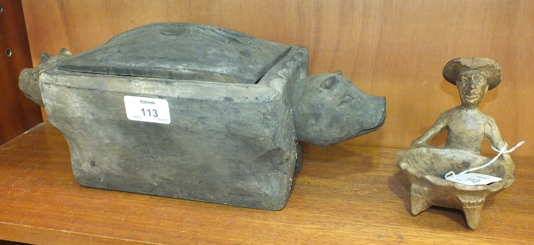 An Ifugao Tribe sacrificial hand-carved wooden box with pig's head handles, 36cm long, 14cm wide,