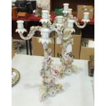 A pair of late-19th century Continental porcelain four-branch candelabra formed as cherub