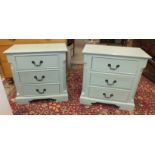 A pair of painted low three-drawer bedside chests on plinth bases, 70cm wide, 68cm high, 40.5cm