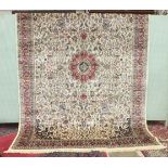 A large Kashmir rug with overall foliate design, on an ivory ground within multiple border, 340 x