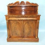 A William IV mahogany chiffonier, the shelved back with carved cresting above a frieze drawer and