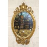 A Victorian oval girandole, the oval gilt gesso frame with foliate cresting and candle holders, 97 x