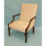 A Chippendale-style armchair with upholstered back and seat and blind fret, carved arms and