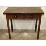 A Georgian small mahogany drop-leaf table having an end frieze drawer, on turned legs with pad feet,