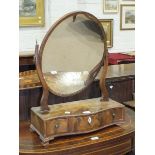 A Georgian-style mahogany serpentine dressing table mirror, the oval plate above three drawers, 65cm