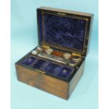 A late-19th century walnut dressing case, the fitted interior with glass boxes and bottles with