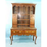 A 19th century inlaid oak dresser, the upper section with shelves flanked by two cupboard doors